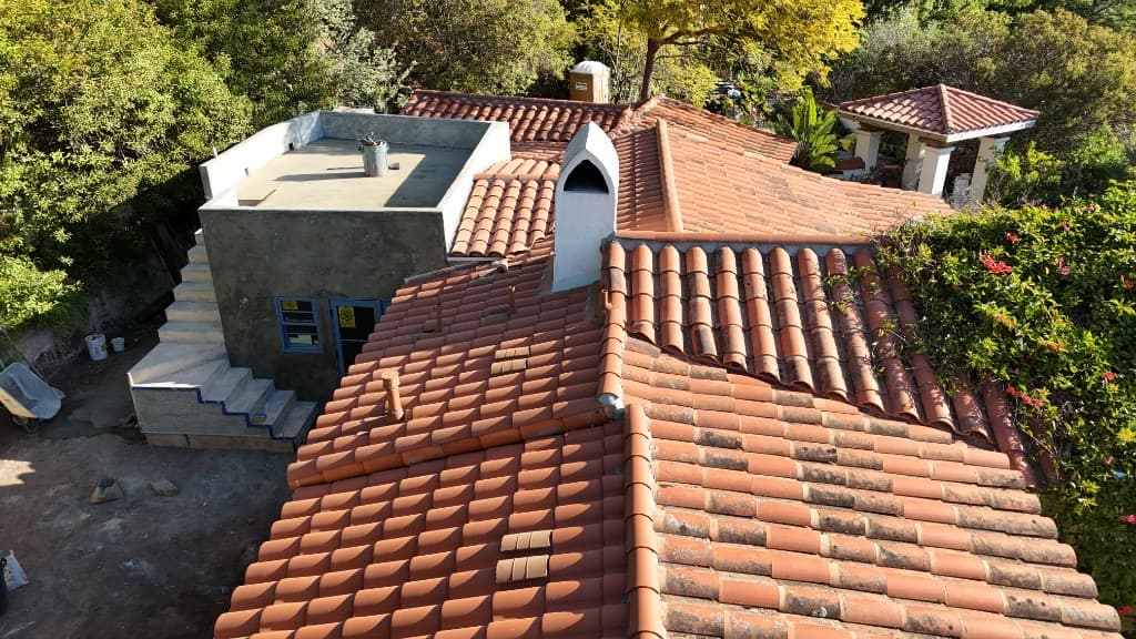 Aerial view of a building complex with terracotta and flat roofing