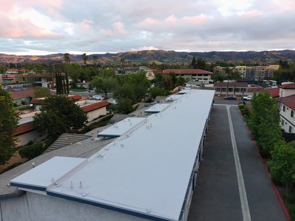 Aerial view of the same building after installation of a clean white TPO roof system in Simi Valley