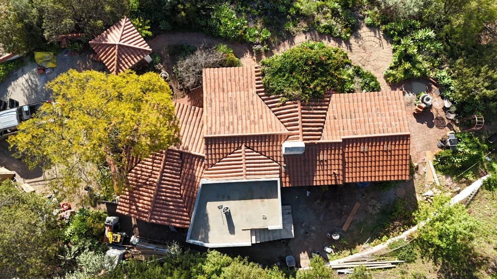 Suburban home featuring a newly installed gray tile roof