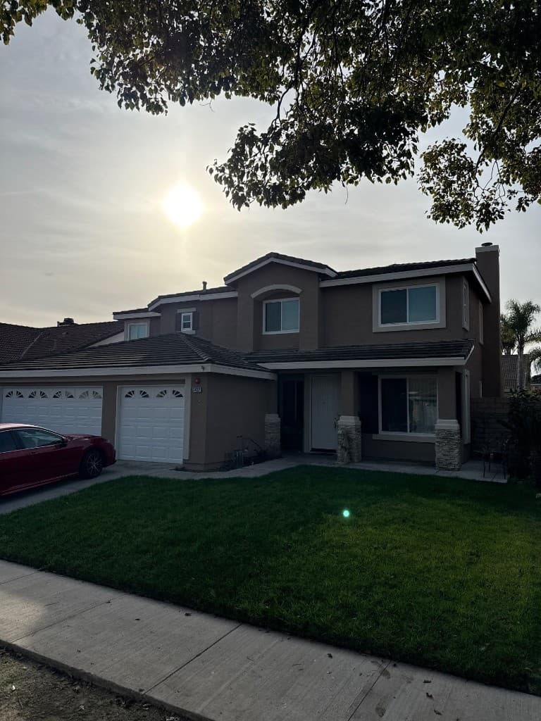 Two-story Oxnard home with dark shake-style tile roofing before replacement