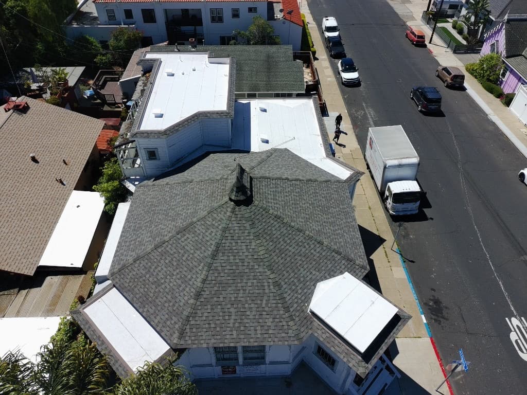 Tile re-roof project with ladder and job-site dumpster