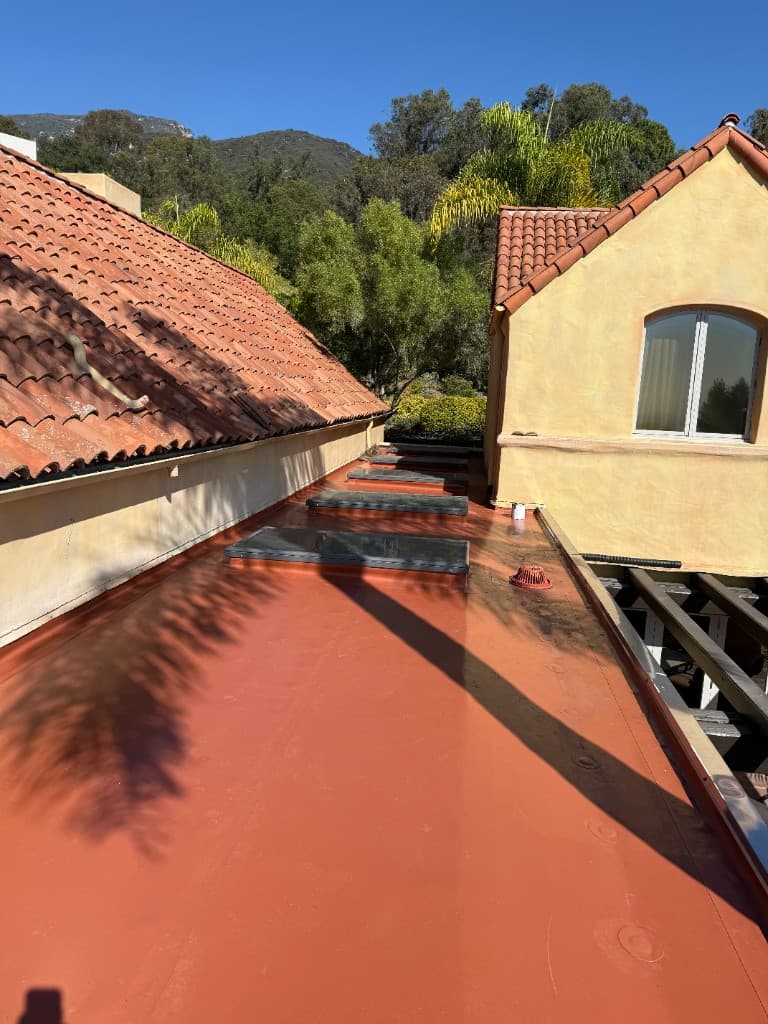 Completed terracotta flat roof coating after Carrillo Roofing project