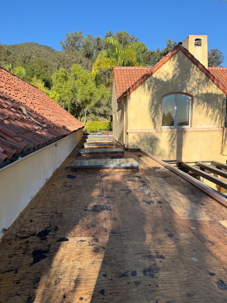 Flat roof stripped to deck during Carrillo Roofing installation