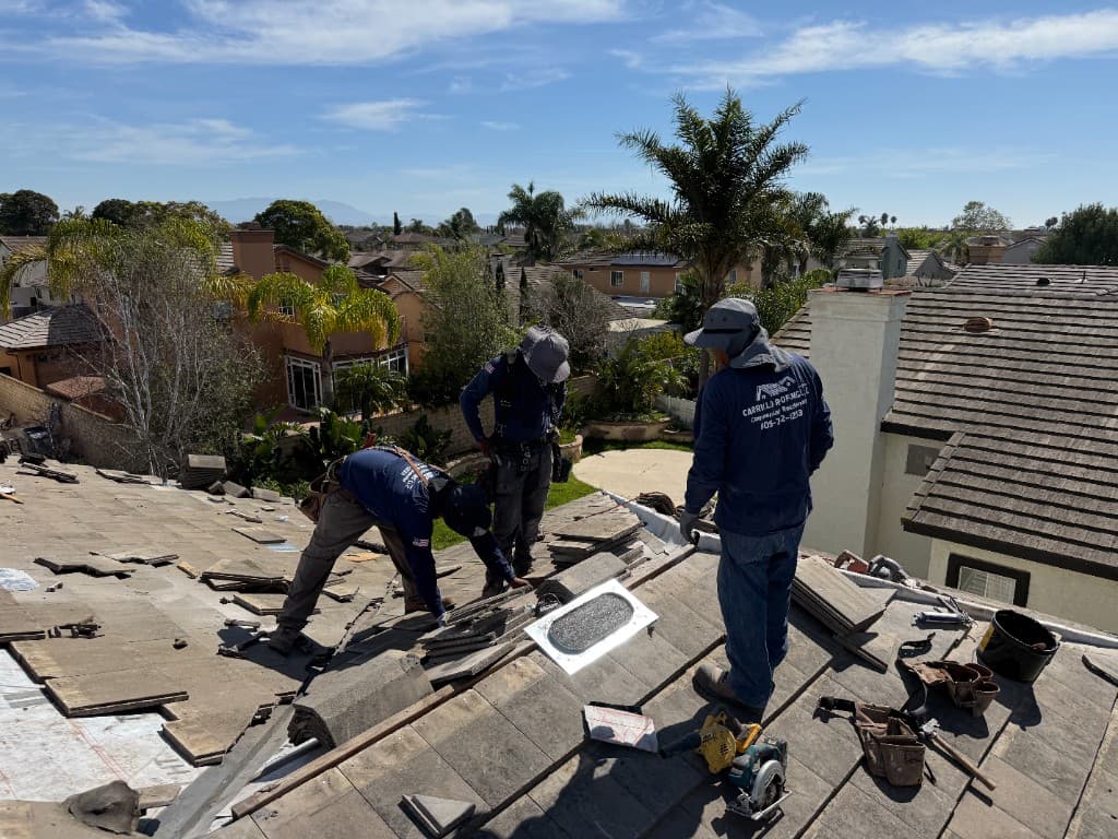 Carrillo Roofing LLC crew installing concrete tile on a residential roof in Southern California